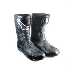 A pair of used black Alpinestars S-MX 5 SE leather racing boots in size 44. In very good condition with minor scratches, they feature comprehensive protection for the toes, heel, ankles, and shin, and are designed to be waterproof.