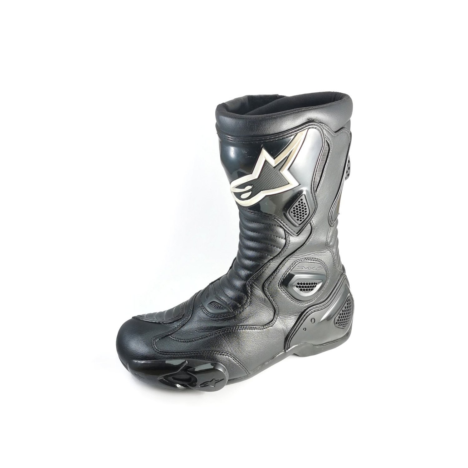 A pair of used black Alpinestars S-MX 5 SE leather racing boots in size 44. In very good condition with minor scratches, they feature comprehensive protection for the toes, heel, ankles, and shin, and are designed to be waterproof.