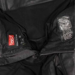 A pair of used black Berik Track racing leather pants in size 48. In very good condition with minor scratches, they feature foam protection at the knees and hips, removable plastic sliders, two front pockets, and a full-length zipper for a race jacket.