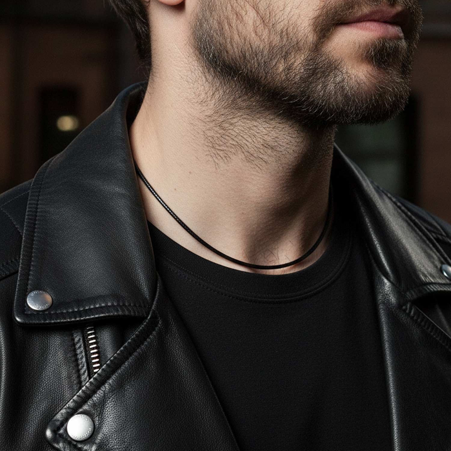 A black Nappa leather bracelet with a silver clasp, showcasing its sleek 4mm width and minimalist unisex design, displayed against a neutral background to highlight its elegant and versatile appeal for motorcyclist