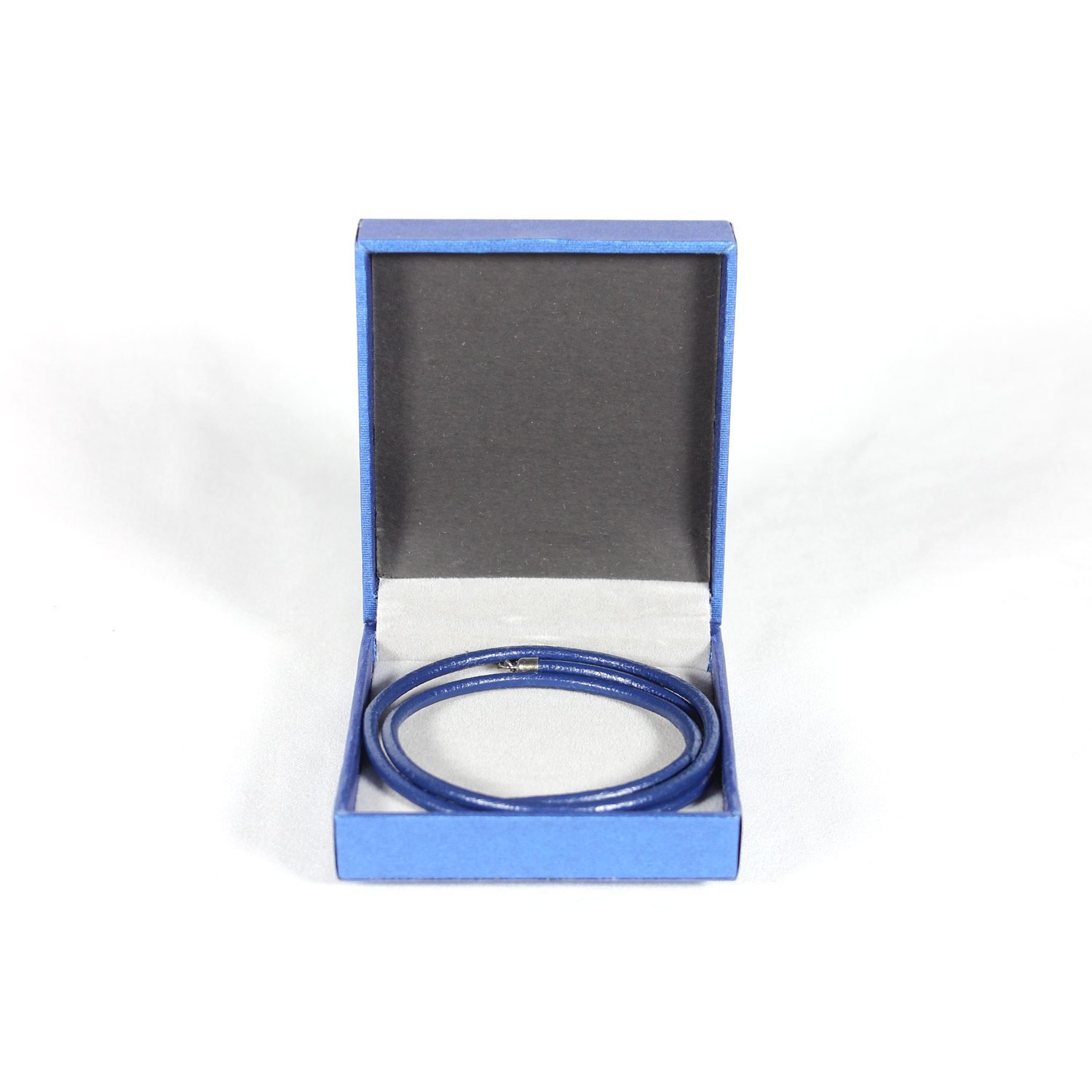 A royal blue Nappa leather watch strap with a stainless steel buckle, shown alongside a watch face to demonstrate its sleek and versatile design.