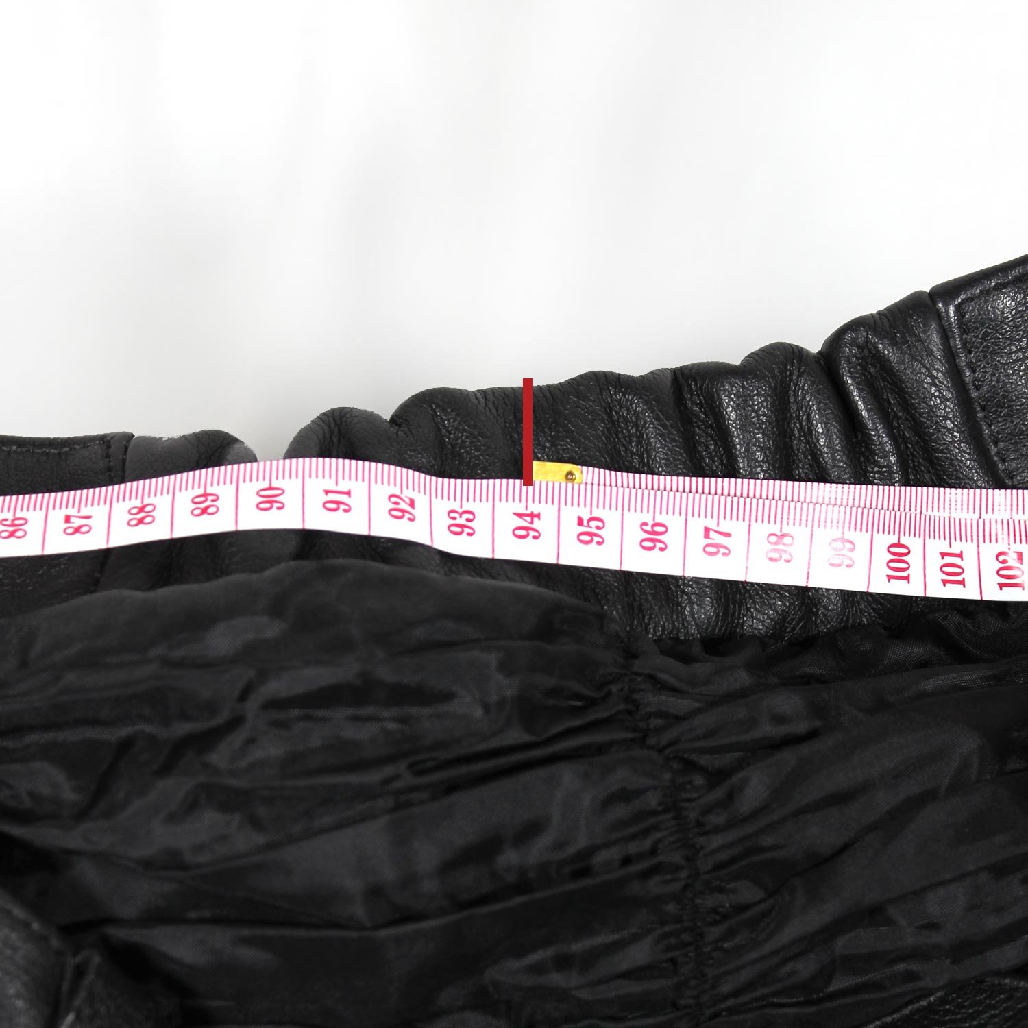 A pair of used black Café-Racer style leather pants, size 56 XXL. The pants are in very good condition with minor use marks and feature a stretch waist, knee and hip padding, and a zipper to connect to a jacket.