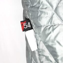 A used blue and crème Dainese Eddie Lawson vintage textile jacket in size 54. In very good condition with minor wear and small spots, it features a classic old-school design with removable sleeves and a hidden large pocket.