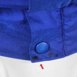 A used blue and crème Dainese Eddie Lawson vintage textile jacket in size 54. In very good condition with minor wear and small spots, it features a classic old-school design with removable sleeves and a hidden large pocket.