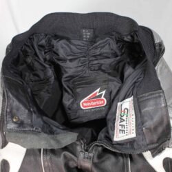 A pair of used black and grey Hein Gericke racing leather pants in size 48. In fairly good condition with minor scratches, they feature foam protection at the knees and hips, a full-length zipper for a jacket, and Velcro pads for knee sliders.