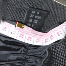 A pair of used black and grey Hein Gericke racing leather pants in size 48. In fairly good condition with minor scratches, they feature foam protection at the knees and hips, a full-length zipper for a jacket, and Velcro pads for knee sliders.