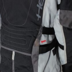 A used black and grey Held touring textile jacket in size M. In fair condition with minor fading and spots, it features CE Level 1 protectors at the elbows and shoulders, a removable thermal liner, ventilation zippers, and is designed to be waterproof and breathable.