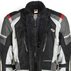 A used black and grey Held touring textile jacket in size M. In fair condition with minor fading and spots, it features CE Level 1 protectors at the elbows and shoulders, a removable thermal liner, ventilation zippers, and is designed to be waterproof and breathable.
