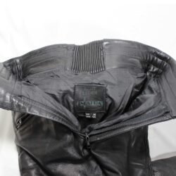 A pair of black Imatra Vintage leather motorcycle pants in size 50 M, designed in a Café Racer style. They are in good condition with minor use marks and feature a stretch waist and thighs for comfort, soft foam knee protection, two front pockets, and a short zipper to connect to a jacket.