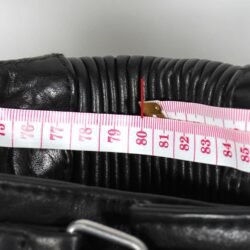 A pair of black Imatra Vintage leather motorcycle pants in size 50 M, designed in a Café Racer style. They are in good condition with minor use marks and feature a stretch waist and thighs for comfort, soft foam knee protection, two front pockets, and a short zipper to connect to a jacket.