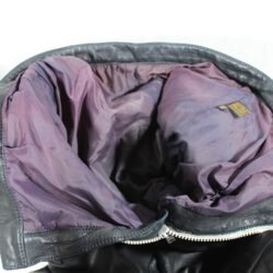 A 56-size dark blue leather city bike saddle in a vintage style. The saddle is in fair condition with general use marks and some discoloration on the white zip and inner liner. It features soft foam padding for protection at the hips and knees but is not waterproof.