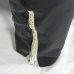 A 56-size dark blue leather city bike saddle in a vintage style. The saddle is in fair condition with general use marks and some discoloration on the white zip and inner liner. It features soft foam padding for protection at the hips and knees but is not waterproof.