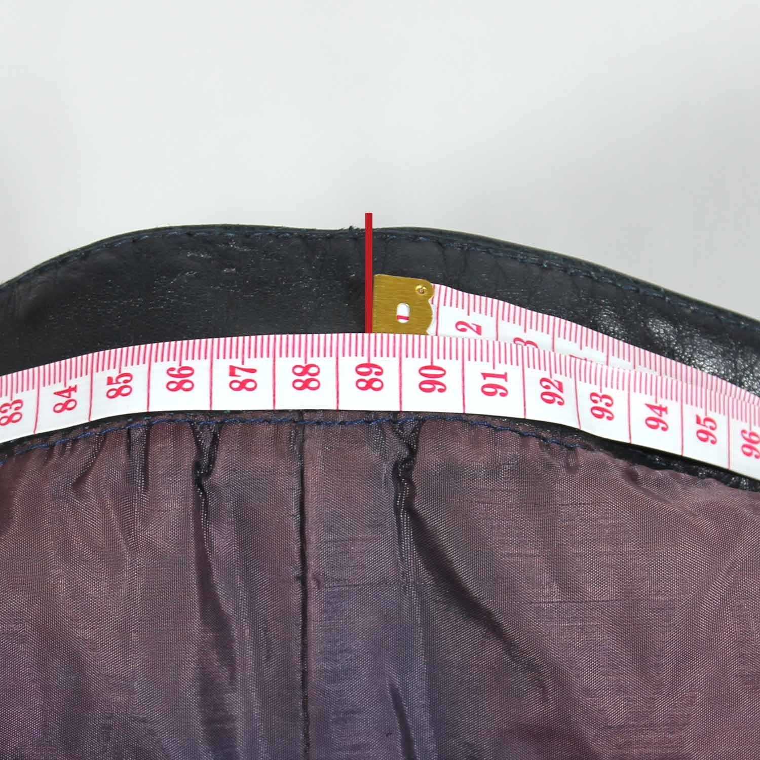 A 56-size dark blue leather city bike saddle in a vintage style. The saddle is in fair condition with general use marks and some discoloration on the white zip and inner liner. It features soft foam padding for protection at the hips and knees but is not waterproof.