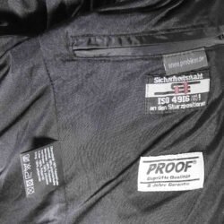 A used black and grey Probiker casual jacket in a mixed leather and textile design, size 50. In good condition with minor wear, it features a DryGate waterproof membrane, a full-circumference zipper for pants, and comes without the thermal liner