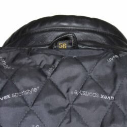 A used black Uvex Sportstyle vintage leather jacket in size 56. In very good condition with only minor aging marks, it features reinforced leather on the elbows, shoulders, and lower back, and a short zipper to connect to pants.