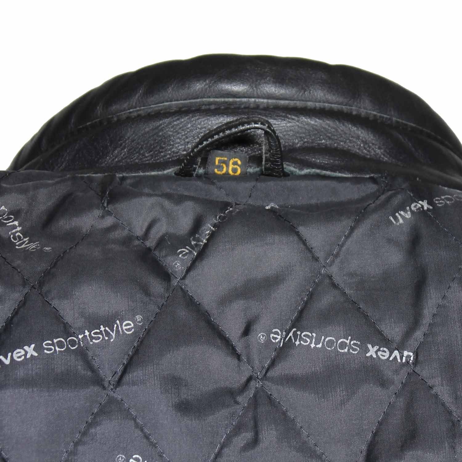 A used black Uvex Sportstyle vintage leather jacket in size 56. In very good condition with only minor aging marks, it features reinforced leather on the elbows, shoulders, and lower back, and a short zipper to connect to pants.