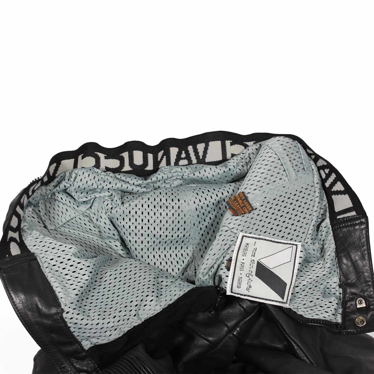 Used Vanucci black leather Café-Racer pants with hip and knee foam protection, featuring connection zippers and perforated ventilation. Shows minor wear and scratches.