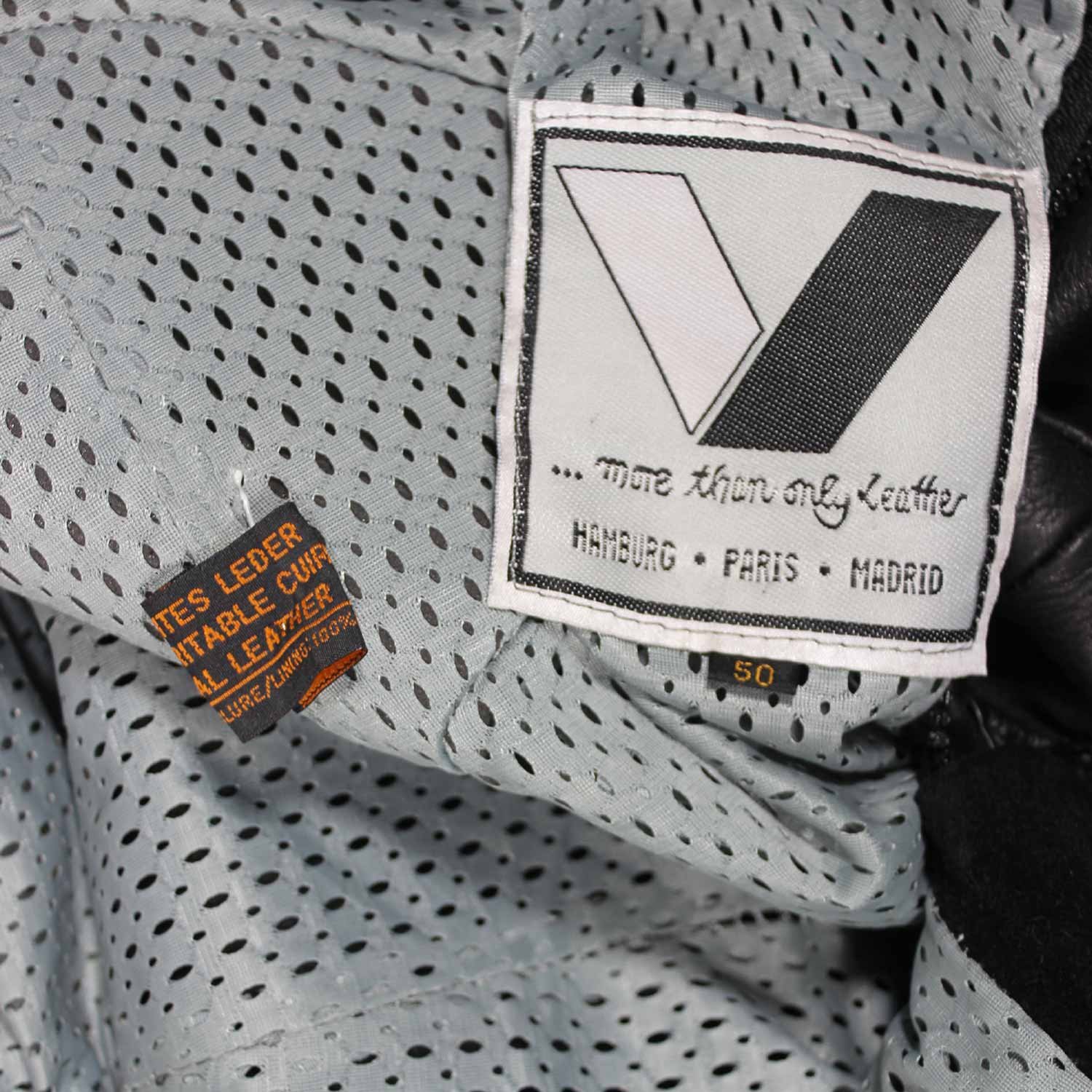 Used Vanucci black leather Café-Racer pants with hip and knee foam protection, featuring connection zippers and perforated ventilation. Shows minor wear and scratches.