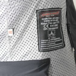 Used Rider-Tec black leather touring jacket with shoulder, elbow, and back protection, ventilation vents, and a combi-jacket connection zipper. Shows minor wear marks.