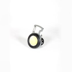 Compact black keychain flashlight with a foldable handle and magnetic base, shown attached to a metal surface, highlighting its USB-C port and multi-mode COB LED for outdoor and emergency use.