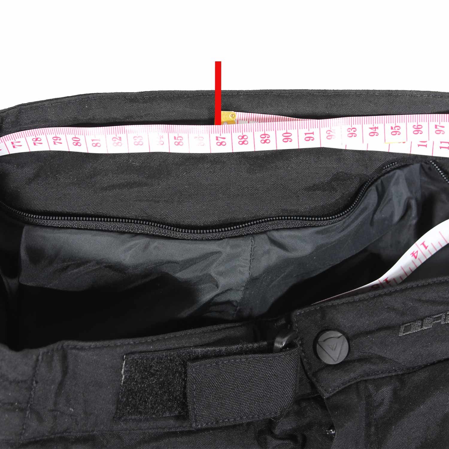 Used Dainese black textile touring trousers with knee and hip protection and a waterproof membrane, showing minor wear marks.