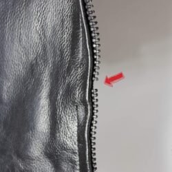 Used Rayo black and white vintage leather jacket with back padding and a combi-pants connection zipper, showing minor wear and a functional zipper with one missing tooth.