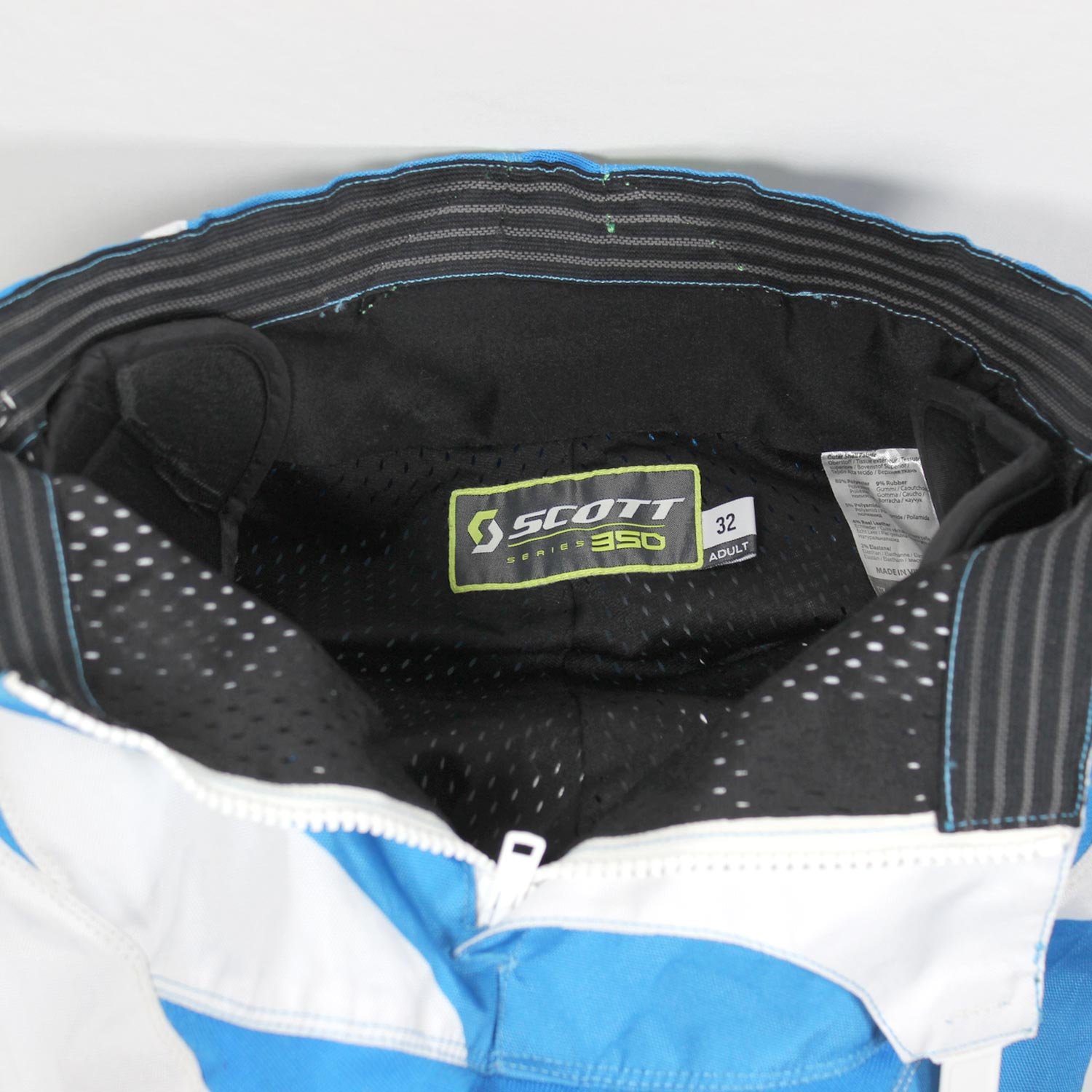 Used Scott Series 350 blue and white cross pants with hip protection and an adjustable waist, showing minor wear marks.