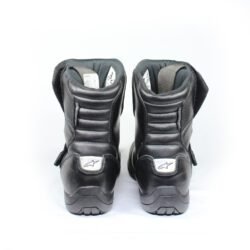 Black Alpinestars Ridge Waterproof touring boots in size 46. Made of synthetic technical material with a double Velcro closure, reinforced shin guard, TPU heel protection, and a vulcanized rubber sole. Features accordion flex zones for mobility and a reflective heel element.