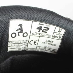 Black Alpinestars Ridge Waterproof touring boots in size 46. Made of synthetic technical material with a double Velcro closure, reinforced shin guard, TPU heel protection, and a vulcanized rubber sole. Features accordion flex zones for mobility and a reflective heel element.