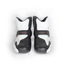 Front view of Alpinestars S-MX 1.1 KTM powerwear motorcycle shoes in size 41. The shoes are made of black and white synthetic leather, featuring accordion flex panels on the sides, a reinforced toe box, and prominent gray TPU sliders on the heel and ankle.