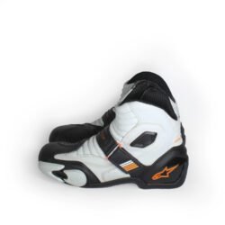 Front view of Alpinestars S-MX 1.1 KTM powerwear motorcycle shoes in size 41. The shoes are made of black and white synthetic leather, featuring accordion flex panels on the sides, a reinforced toe box, and prominent gray TPU sliders on the heel and ankle.