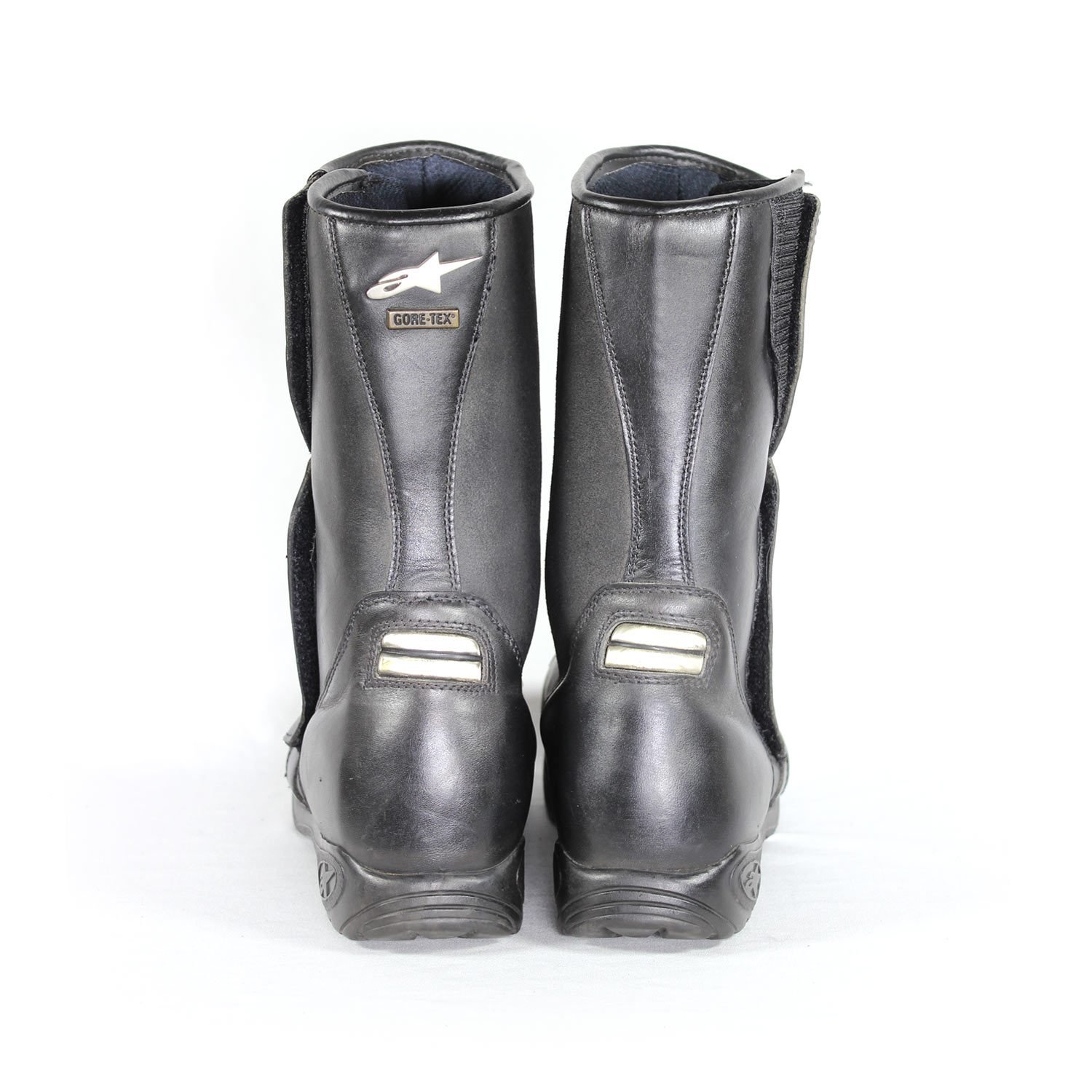 A pair of black leather Alpinestars Touring Classic boots in size 39. The boots feature a Gore-Tex waterproof membrane and protective reinforcements on the toes, shin, ankles, and heel, along with a reinforced sole, gear lever protection, and rear reflectors. They show minor wear marks.