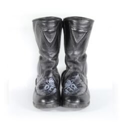 A pair of customized black leather Dainese touring boots in size 40, featuring a unique, artistic paint design applied by the Revver Workshop. The boots offer protection for the toes, shin, ankles, and heel, with a reinforced sole. They show some wear marks and have had the gear and brake lever protectors artistically removed as part of the custom design.