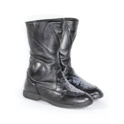 A pair of customized black leather Dainese touring boots in size 40, featuring a unique, artistic paint design applied by the Revver Workshop. The boots offer protection for the toes, shin, ankles, and heel, with a reinforced sole. They show some wear marks and have had the gear and brake lever protectors artistically removed as part of the custom design.