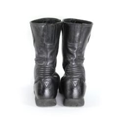 A pair of customized black leather Dainese touring boots in size 40, featuring a unique, artistic paint design applied by the Revver Workshop. The boots offer protection for the toes, shin, ankles, and heel, with a reinforced sole. They show some wear marks and have had the gear and brake lever protectors artistically removed as part of the custom design.