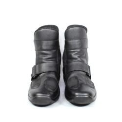 A pair of black leather touring boots, size 41, made in Germany. The boots feature a Gore-Tex membrane for waterproofing and have a high shaft. Key details include ankle protectors on both sides, a reinforced toe box, and a shin protector. The sole is a non-slip rubber with a tire tread pattern. The interior is padded with latex foam for comfort, and the insole is plastic-reinforced with a galvanized steel shank for torsion resistance. Minor wear is visible on the gear lever protection pad and the sole.