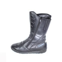 A pair of black leather Gaerne touring boots in size 45. The boots feature protective reinforcements on the toes, shin, ankles, and heels, along with gear and brake lever protection. They are in fairly good condition with some wear marks.