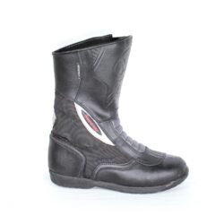 A pair of black leather MC MP-ASU Caronte touring boots in size 39. The boots feature protective reinforcements on the toes, shin, ankles, and heel, with a reinforced sole and gear/brake lever protection. They are in fairly good condition with some wear marks and are no longer waterproof.