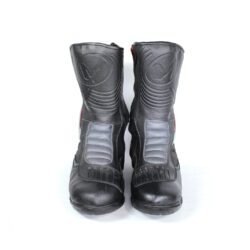 A pair of black leather MC MP-ASU Caronte touring boots in size 39. The boots feature protective reinforcements on the toes, shin, ankles, and heel, with a reinforced sole and gear/brake lever protection. They are in fairly good condition with some wear marks and are no longer waterproof.