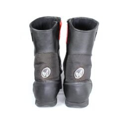 A pair of black leather MC MP-ASU Caronte touring boots in size 39. The boots feature protective reinforcements on the toes, shin, ankles, and heel, with a reinforced sole and gear/brake lever protection. They are in fairly good condition with some wear marks and are no longer waterproof.