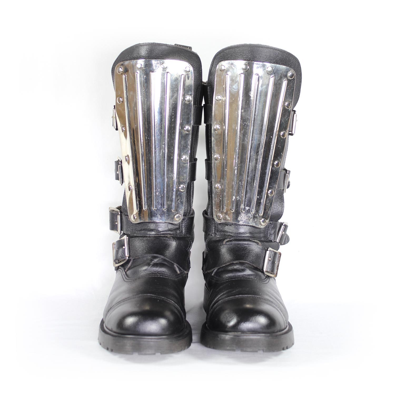 A pair of black leather Chopper-style cruiser boots by Underground Shoes in size 39. The boots feature a classic English design with metallic hardware accents and protective reinforcements on the toe, shin, and heel. They are in very good condition with minor wear marks.