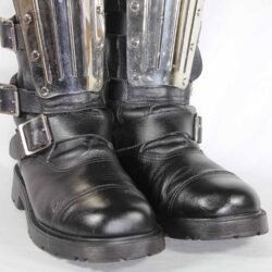 A pair of black leather Chopper-style cruiser boots by Underground Shoes in size 39. The boots feature a classic English design with metallic hardware accents and protective reinforcements on the toe, shin, and heel. They are in very good condition with minor wear marks.