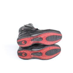 Side view of black Vanucci VTB4 short motorcycle boots in size 44. The boots are made of nappa leather with a low shaft, two velcro straps for closure, textured carbon fiber panels on the sides, and a 3M Scotchlite reflector on the heel.