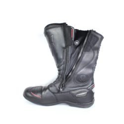 A pair of black Vanucci VTB touring boots in size 44, made of nappa leather. They feature a SympaTex membrane, two side zippers, a tall shaft, and protection including a wide shin guard, carbon side inserts, and reinforced ankles, toes, and heel. The boots show wear marks and the rear reflectors have lost their reflectivity.