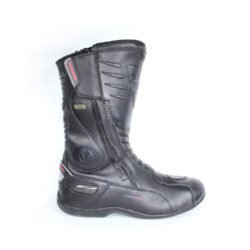 A pair of black Vanucci VTB touring boots in size 44, made of nappa leather. They feature a SympaTex membrane, two side zippers, a tall shaft, and protection including a wide shin guard, carbon side inserts, and reinforced ankles, toes, and heel. The boots show wear marks and the rear reflectors have lost their reflectivity.
