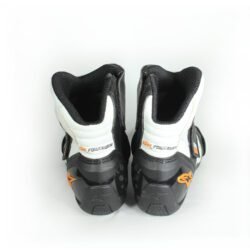 A pair of black and white Alpinestars S-MX 1.1 KTM Powerwear boots, size 44, in like-new condition. Features lightweight leather construction, accordion flex zones for walking, TPU ankle sliders, a grippy sole, and protection for the toes, heel, and shift area.