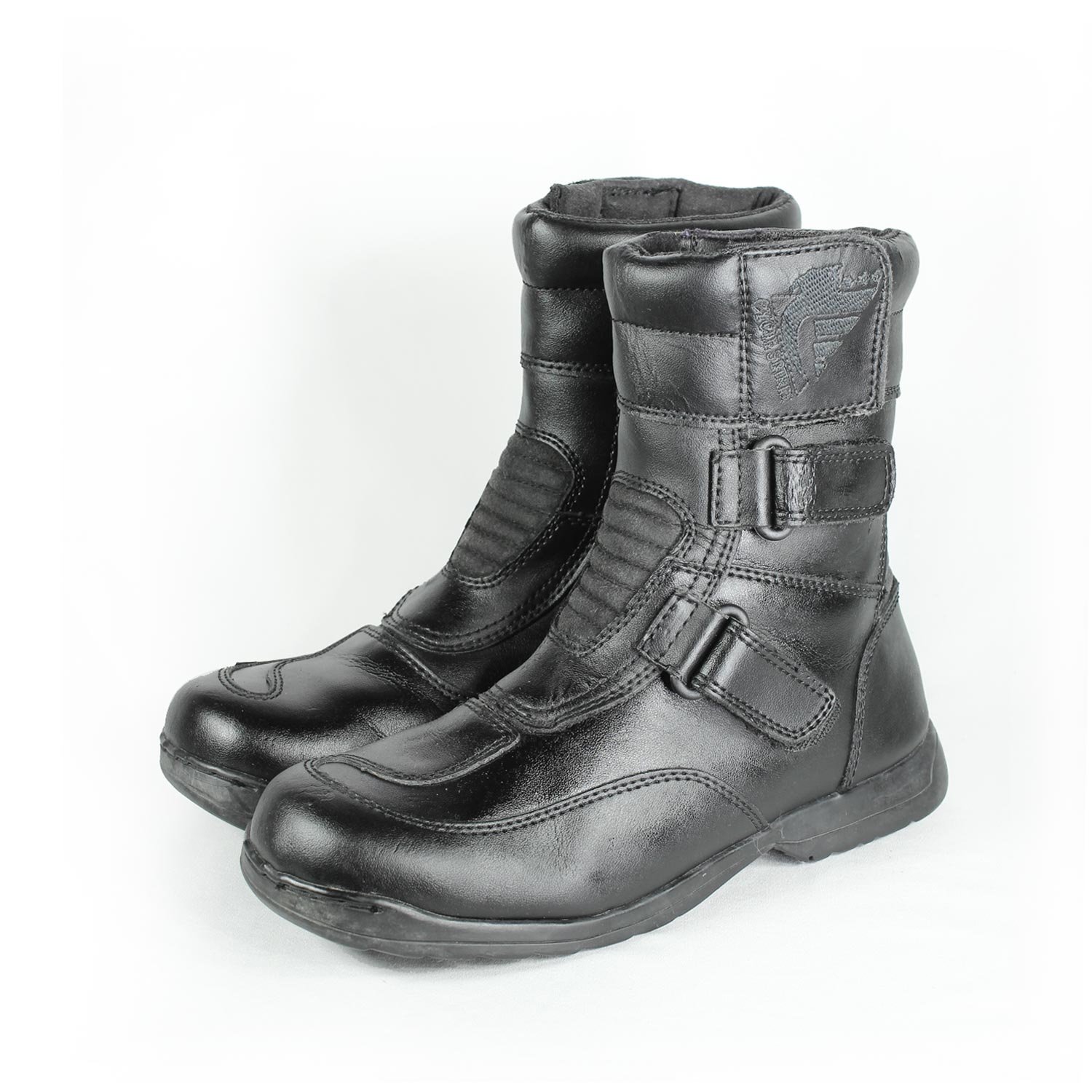 A pair of black synthetic leather motorcycle boots, size 37, in fair condition. Features typical touring and street styling with protection for the toes, heel, shin, and sole. Shows signs of aging, including cracks and wrinkles on the PU-leather.
