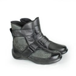 A pair of black Daytona Shorty perforated leather motorcycle boots, size 43, in very good condition. Features full-grain cowhide construction, ankle protectors, a non-slip sole, and a climate insole for warm-weather riding. Shows minor wear, including a small spot on the side.