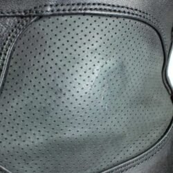 A pair of black Daytona Shorty perforated leather motorcycle boots, size 43, in very good condition. Features full-grain cowhide construction, ankle protectors, a non-slip sole, and a climate insole for warm-weather riding. Shows minor wear, including a small spot on the side.