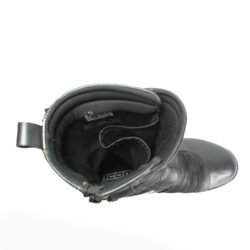 A pair of black ICON ONE THOUSAND 12" full-grain leather motorcycle boots, size 47, in good condition. Features ankle armor, reinforced shifter and shin protection, water-repellent leather, and a Goodyear welt construction. Shows typical wear, a missing screw on a back plaque, and a minor buckle flaw that does not hinder function.